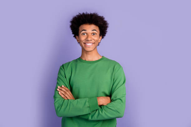 istock Photo of excited cheerful guy wear green pullover arms folded empty space isolated purple color background 2012442016