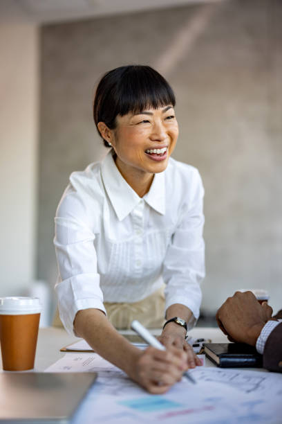 istock Beautiful business woman looking over documents at office desk 2012458601