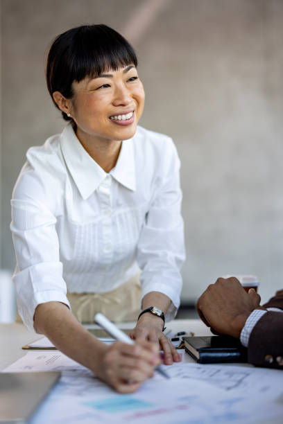 istock Businesswoman examining documents at desk 2012458610