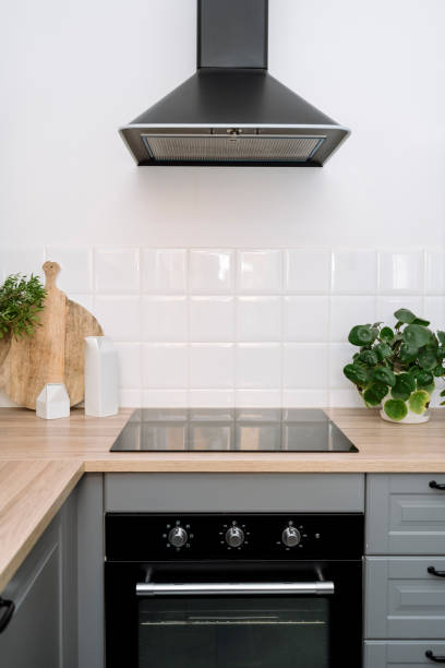 istock Hood extractor, glass ceramic stove, electric oven at modern kitchen 2012461305