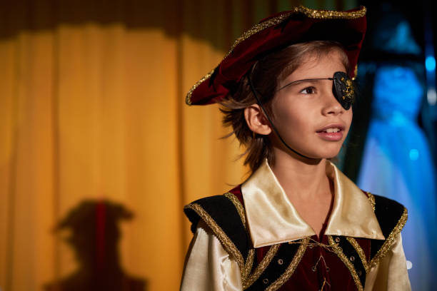 istock Boy wearing pirate costume performing on stage 2012469739