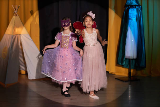 istock Two Girls Wearing Costumes Acting on Stage 2012470310
