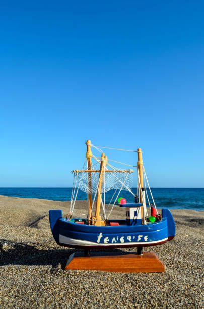 Photo Picture of a Toy Boat on the Sand Beach