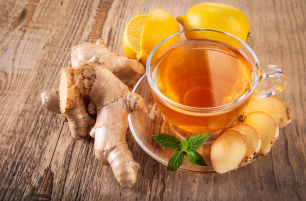 istock Ginger tea with lemon honey and thyme at white wooden board in r 2012505704
