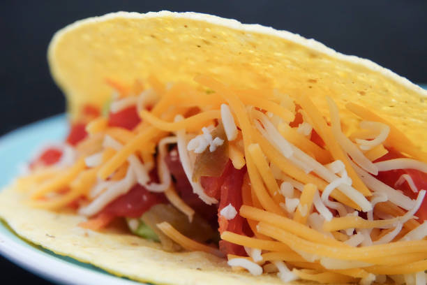 istock Delicious taco with cheese, tomato, onions, and peppers 2012506233