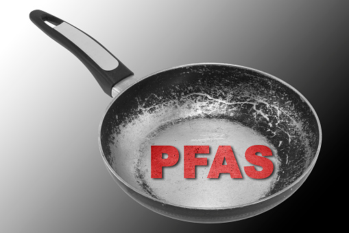 Dangerous PFAS Perfluoroalkyl and Polyfluoroalkyl substances in cookware, non stick frying pan - Concept image with pan and cooking bottom worn and damaged