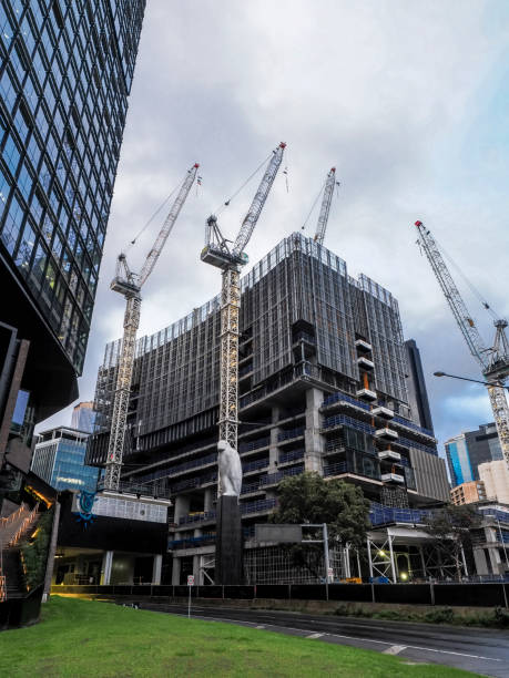 Melbourne, Australia - Aug 30, 2022: Building construction activities beside the Docklands Highway (Wurundjeri Way). Perspective view from street level.