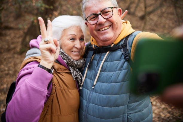 istock Hiking Memory: Senior Couple Snaps Photo with Smartphone on Trail. 2012561881