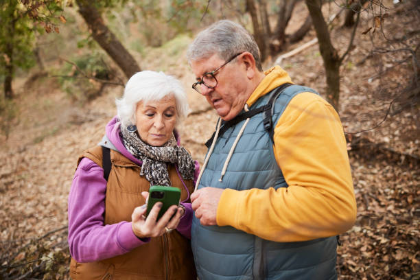istock Navigating the Trail: Senior Couple Checks Smartphone App While Hiking 2012561889