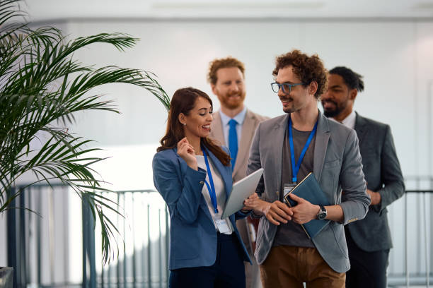 istock Happy entrepreneur using touchpad while going with her colleagues on a meeting in the office. 2012564183