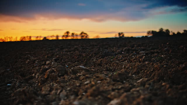 Dolly Shot of Dirt Ground against Cloudy Sky during Sunset