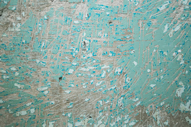 texture of a concrete wall with the problem of removing old oil paint from the surface coating, for further filling of the wall