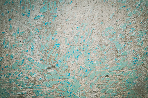 texture of a concrete wall with the problem of removing old oil paint from the surface coating, for further filling of the wall
