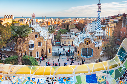 Barcelona, Antoni Gaudi Park Guell buildings, mosaics and cityscape of Barcelona with the sea.
