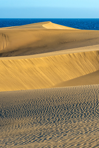 A panoramic shot of beautiful sand dunes with low and high peaks in Namib desert