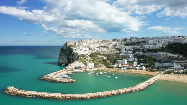 The town of Peschici and its marina in Europe, Italy, Puglia, towards Foggia, in summer, on a sunny day.
