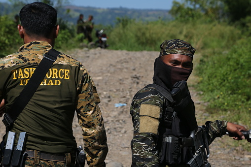 Mindanao, Cotabato City - Philippines, August 12, 2019:  The primary mode of transportation for MILF guerrillas in the jungle of Cotabato is the motorbike. Along the route to Badr Camp, it's common to see many MILF members guarding villages with their motorbikes.