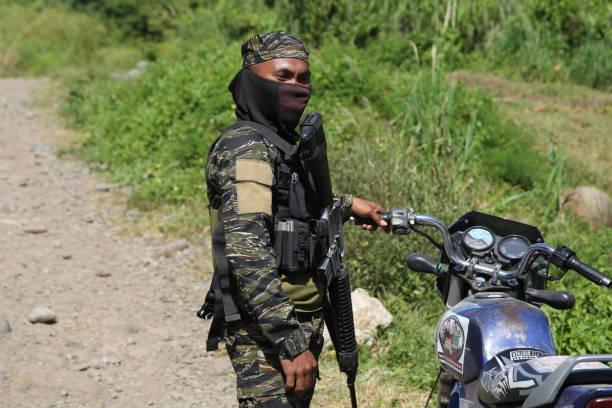 Mindanao, Cotabato City - Philippines, August 12, 2019:  The primary mode of transportation for MILF guerrillas in the jungle of Cotabato is the motorbike. Along the route to Badr Camp, it's common to see many MILF members guarding villages with their motorbikes.