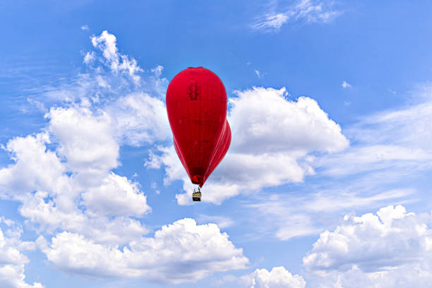 Thousands of multi-colored balloons float toward the sky to create an American Flag
