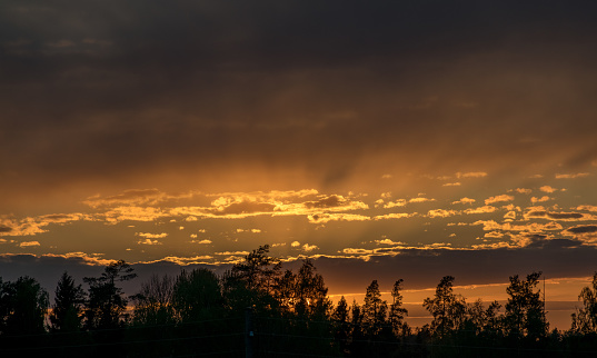 landscape with a beautiful sunset sky over the roof of the house