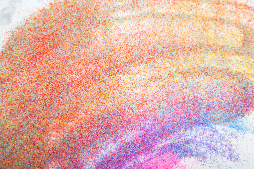 Abstract gradient of powdered rainbow colors.