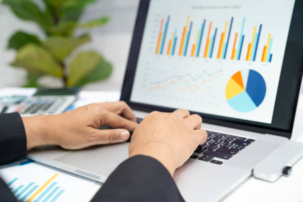 istock Asian accountant working and analyzing financial reports project accounting with chart graph and calculator in modern office, finance and business concept. 2012628502