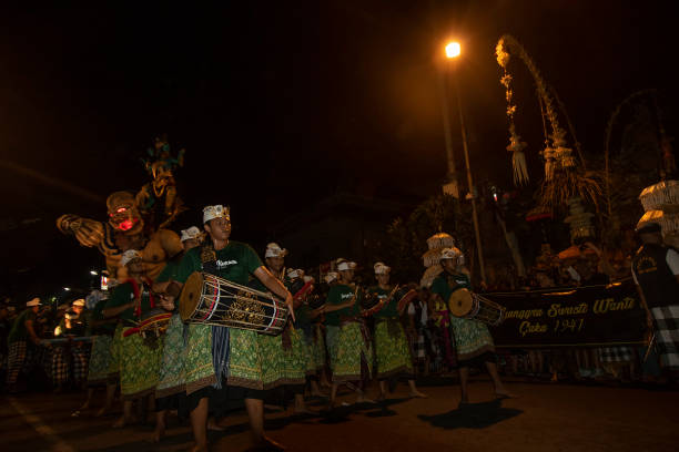 Kuta, BALI, INDONESIA - MARCH 2019: Balinese carry the ogoh-ogoh, the giant menacing-looking dolls during the ogoh-ogoh parade on the eve of Nyepi, the Balinese Hindu Day of Silence that marks the arrival of the new Saka lunar year on March 6, 2019 in Kuta, Bali, Indonesia.