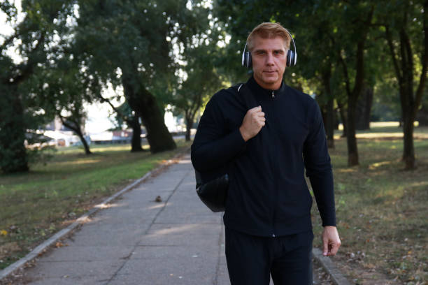istock Mature  man walking and listen music 2012636747