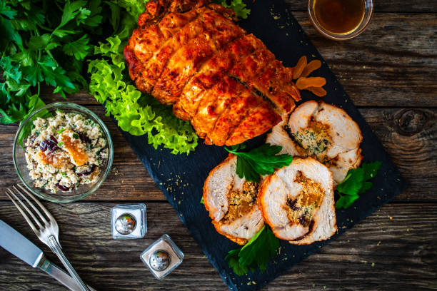 stuffed turkey breast roulade with dried apricots and cranberries on wooden table - filet mignon bacon fillet steak - fotografias e filmes do acervo