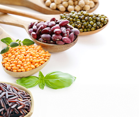 assortment of cereals peas beans lentils in spoons