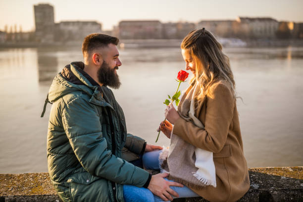 istock Man giving rose to his woman 2012729049