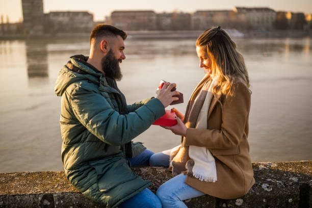 istock Man giving presents to his woman 2012729592