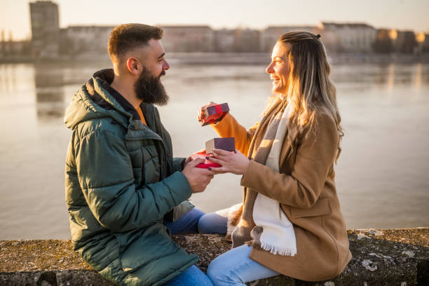 istock Man giving presents to his woman 2012729599