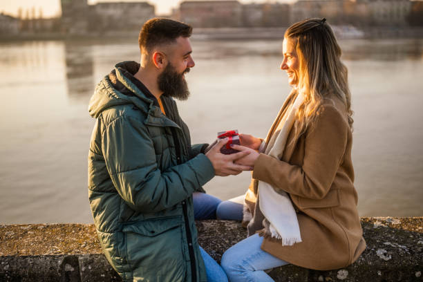 istock Woman giving presents to her man 2012730165
