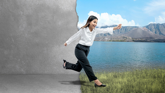 Asian businesswoman running outside. Leave the comfort zone. Concept of expanding horizon