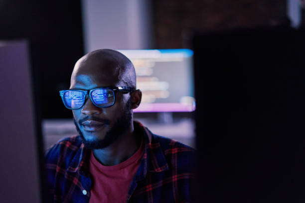 cyber security, black man and code reflection in eyewear, hacking and software update in office. african american male employee, programmer or it specialist with glasses, focus and cloud computing - segurança de rede - fotografias e filmes do acervo