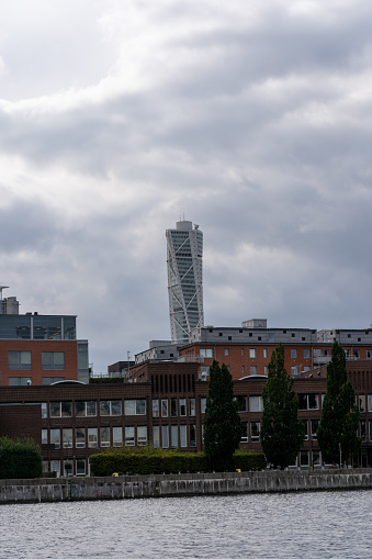 Malmoe, Sweden – August 24, 2023: The view of Turning Torso against the backdrop of a cloudy sky. Malmo, Sweden