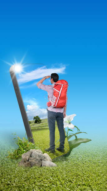 Asian man with a backpack standing with a field view on the mobile phone screen. Traveling concept