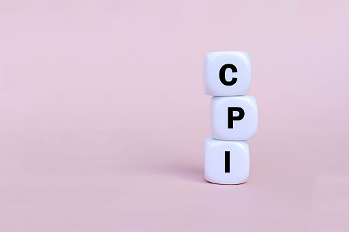 CPI - Consumer Price Index symbol on white blocks on pink background. Business and CPI concept. Copy space.