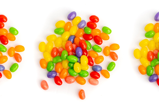 Piles of jelly beans on a white background.