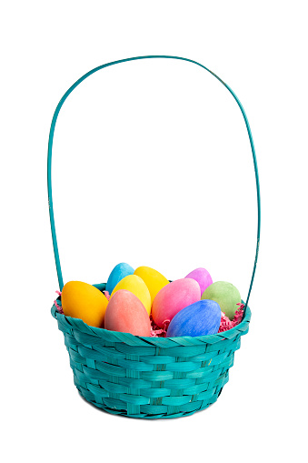A basket of dyed Easter eggs on a white background.