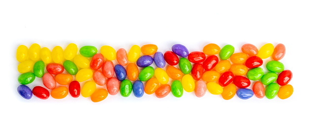 A lone of jelly beans in a long rectangle shape isolated on a white background.