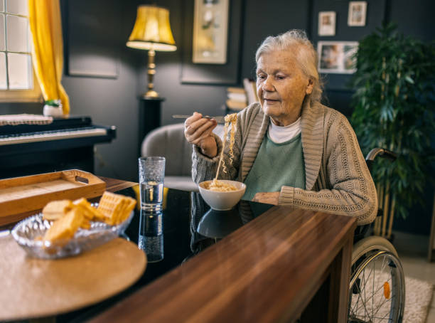 istock an elderly woman is eating lunch at home 2012805907