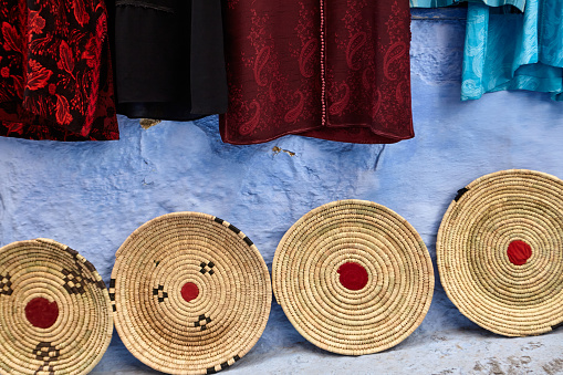 Shopping street with Moroccan woven trays Chefchaouen, Morocco, North Africa.