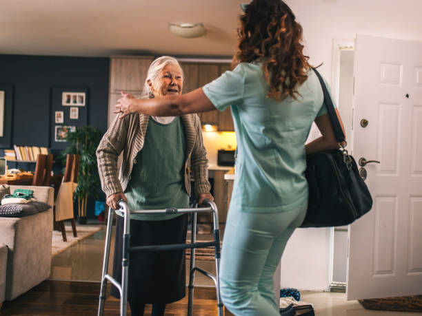 istock a nurse visits an elderly disabled woman at home and helps her 2012824967