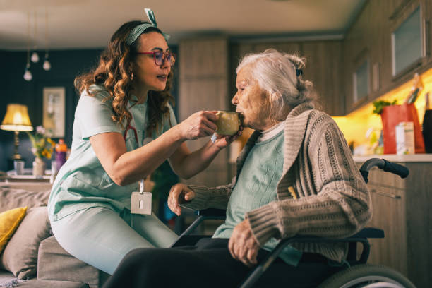 istock a nurse visits an elderly disabled woman at home and helps her 2012827639