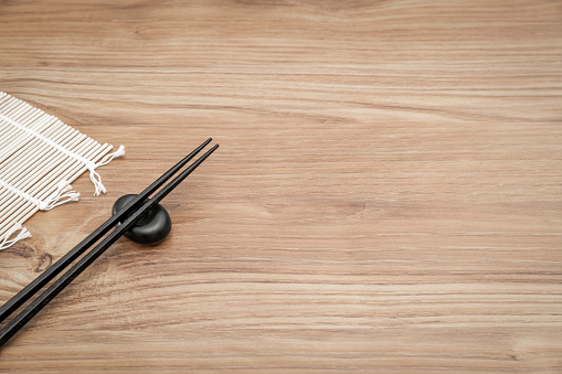 Chopsticks and bamboo sushi mat \
