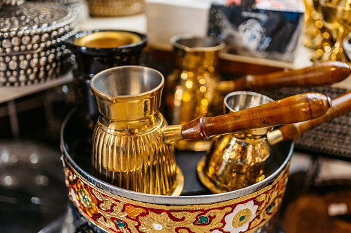 Traditional coffee pot souvenirs on a tray for sale at Al-Mubarakiya Bazaar in Kuwait City.