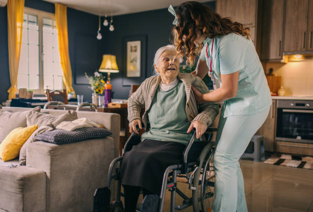 istock a nurse visits an elderly disabled woman at home and helps her 2012833044