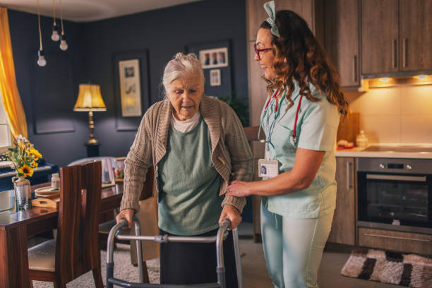 istock a nurse visits an elderly disabled woman at home and helps her 2012834096